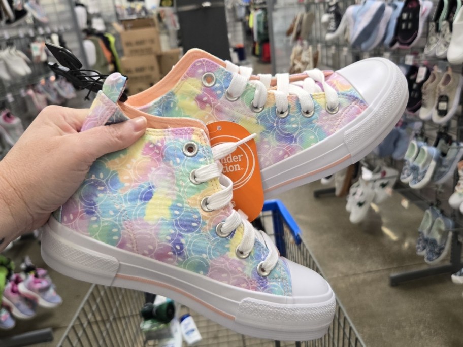 woman holding Wonder Nation Kids Platform High Top Sneakers in walmart