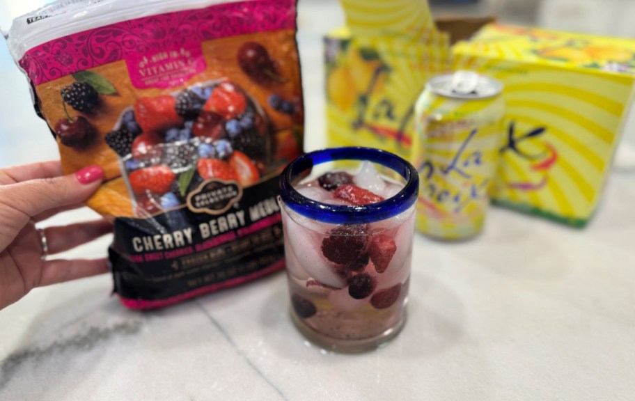 adding frozen berries to sparkling water