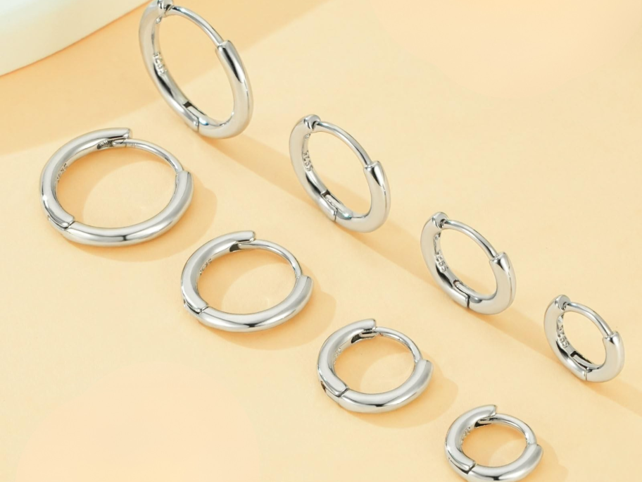 four pairs of silver hoop earrings