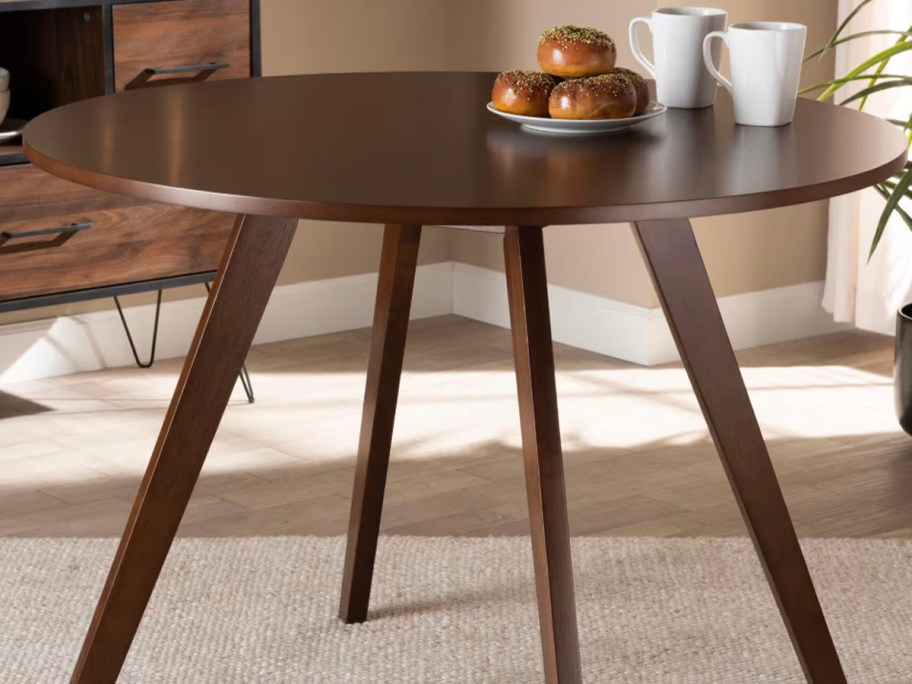 dark wood dining table with fruit on top 