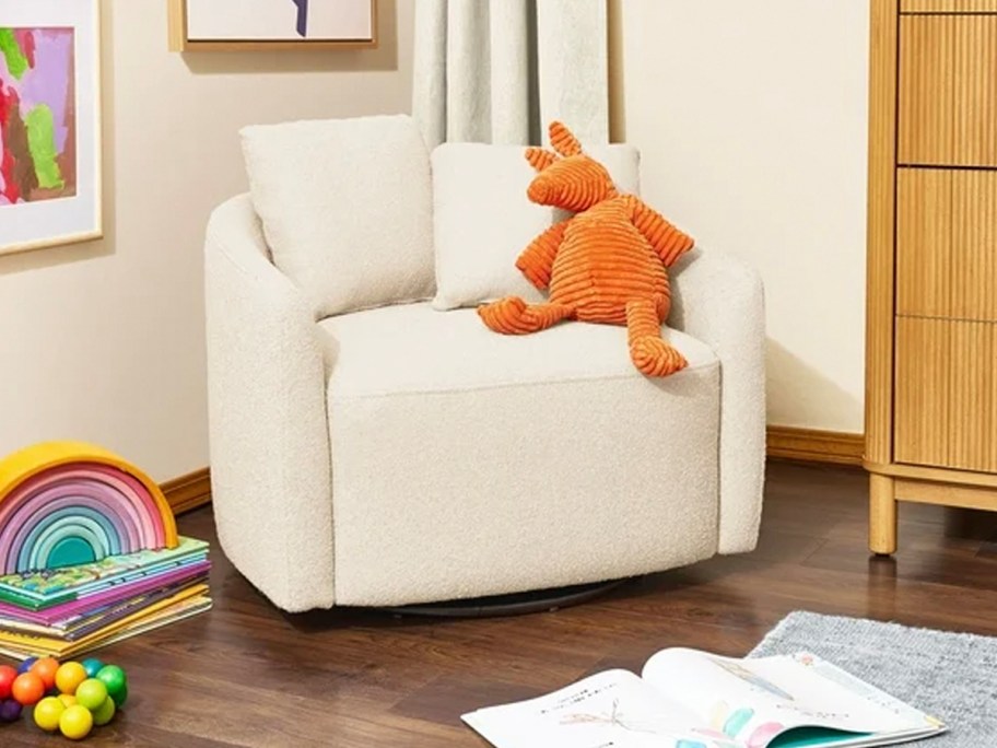 white chair with orange stuffy on it 