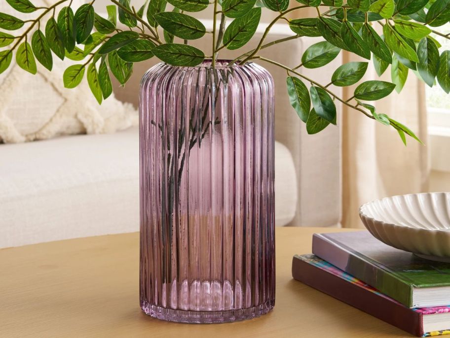 Better Homes & Gardens 9.8" Pink Ribbed Cylinder Glass Vase with stems in it on table