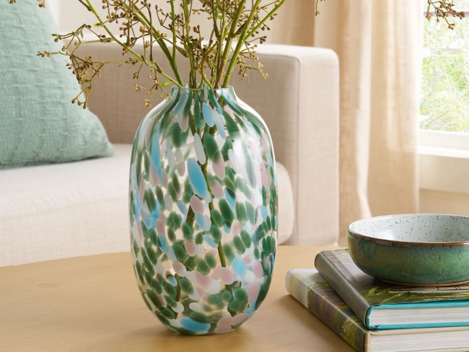 Better Homes & Gardens 10" Green Painted Glass Vase with stems in it on table