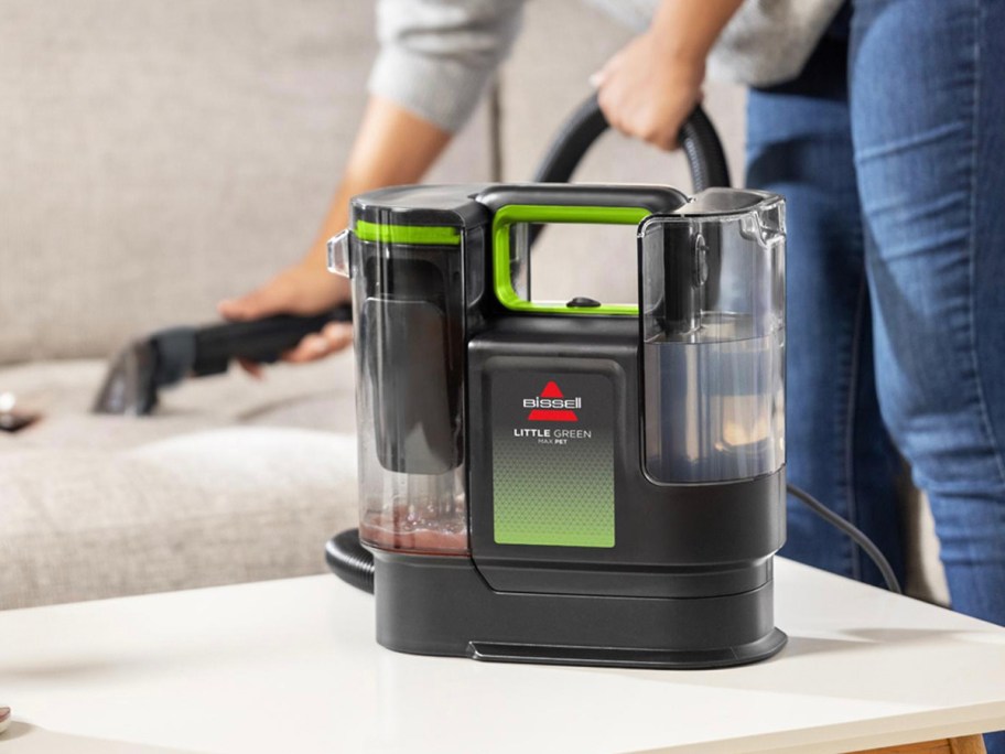 black and green carpet cleaner on table