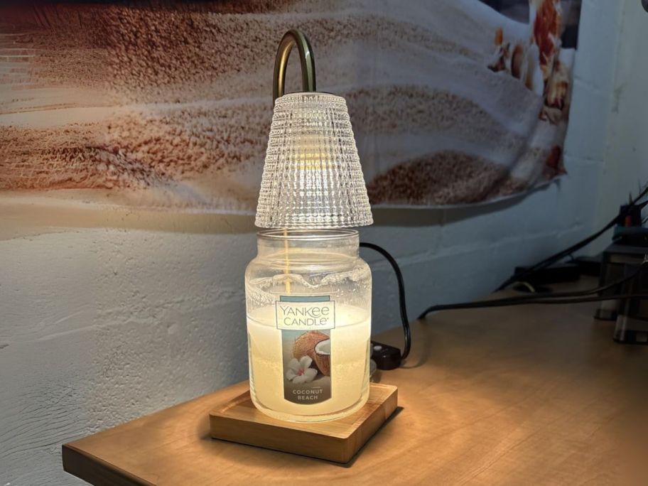 candle warmer lamp with large candle on it on table