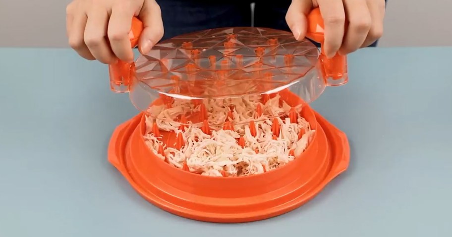 person using a chicken shredder