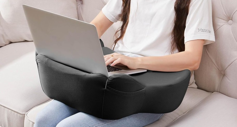 person using a lapdesk and computer