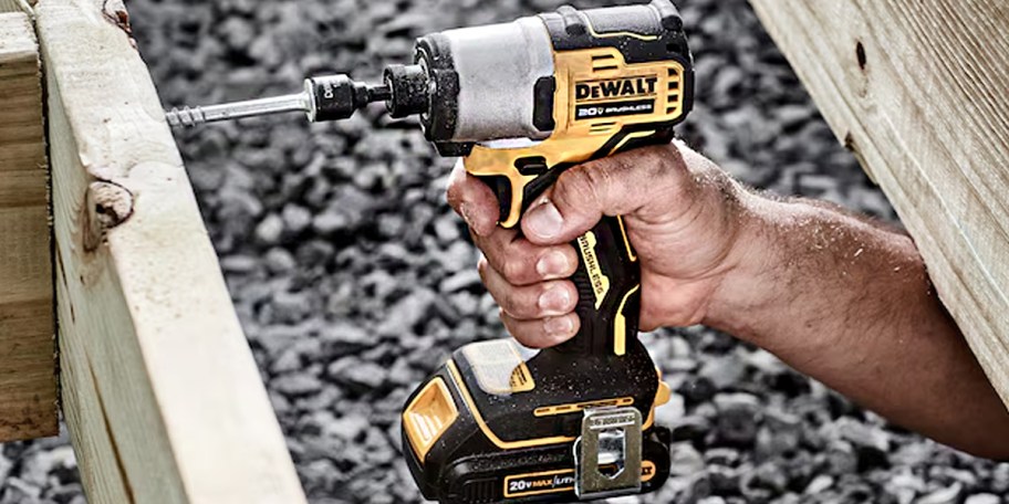 hand using dewalt power tool on wood