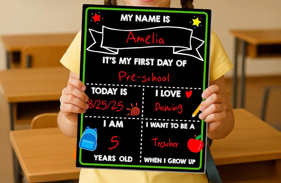 child holding a first day of school sign