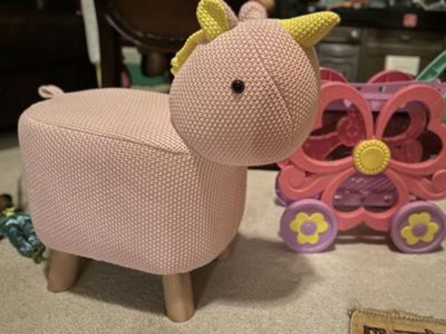 pink unicorn foot stool in playroom