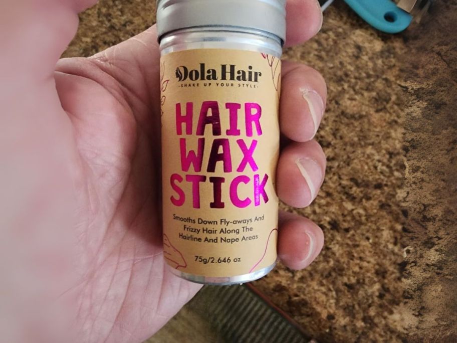 hair wax stick in hand