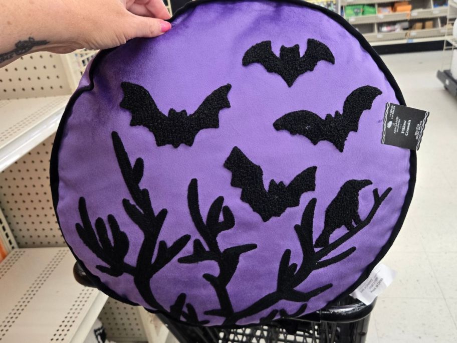 Ashland Purple Halloween Bat & Crow Tree Accent Pillow in hand in store