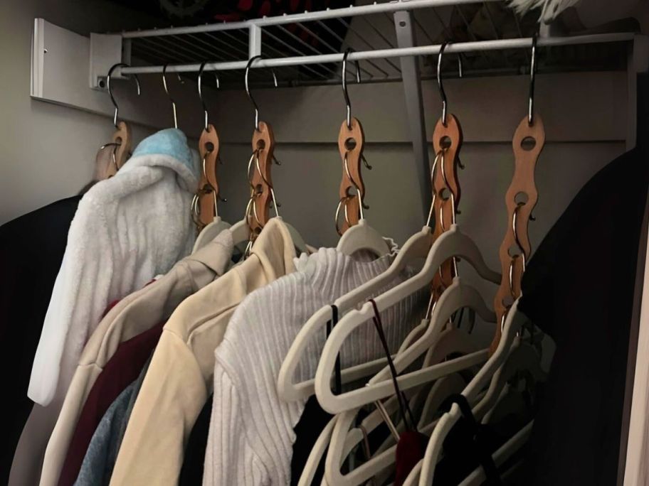 vertical hangers hanging in closer with clothing on them