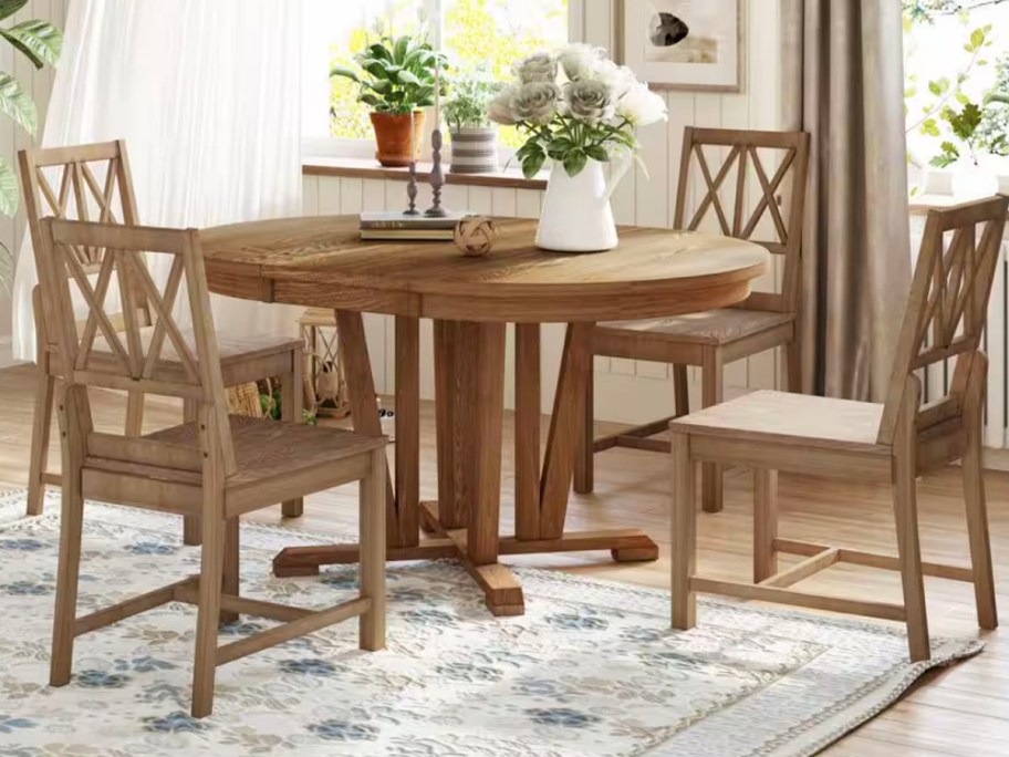 wooden table and 4 chairs with flowers on top 