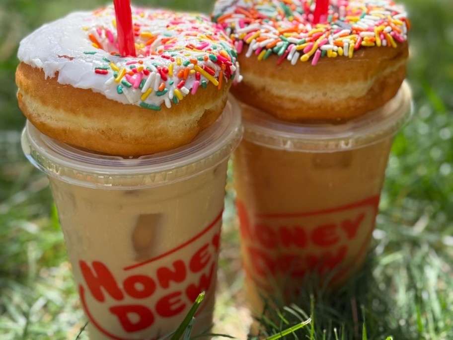 two iced drinks with donuts on top