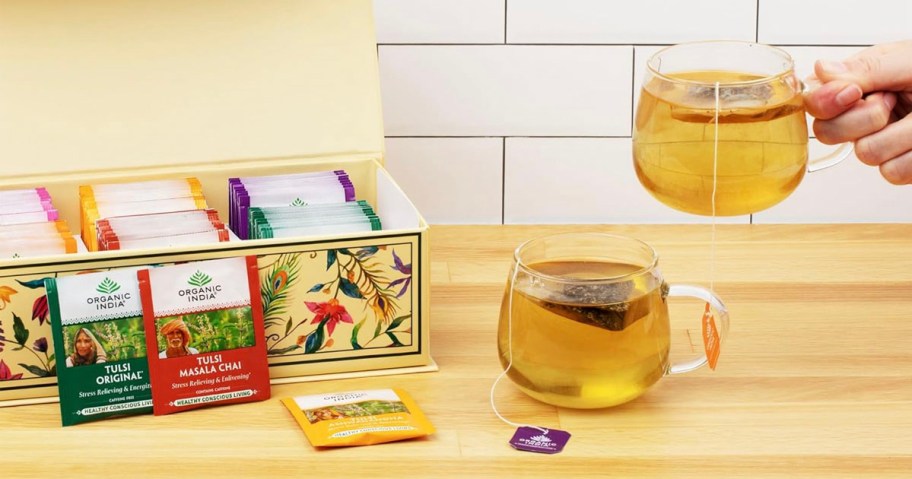 india tea box, with tea packs and cup of tea on table