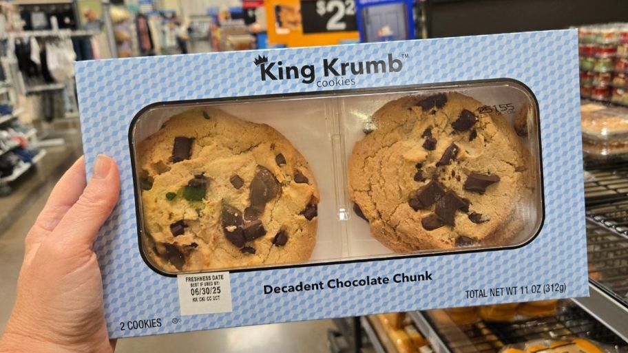 a womans hand holding a box of king krumb cookies in chocolate chunk