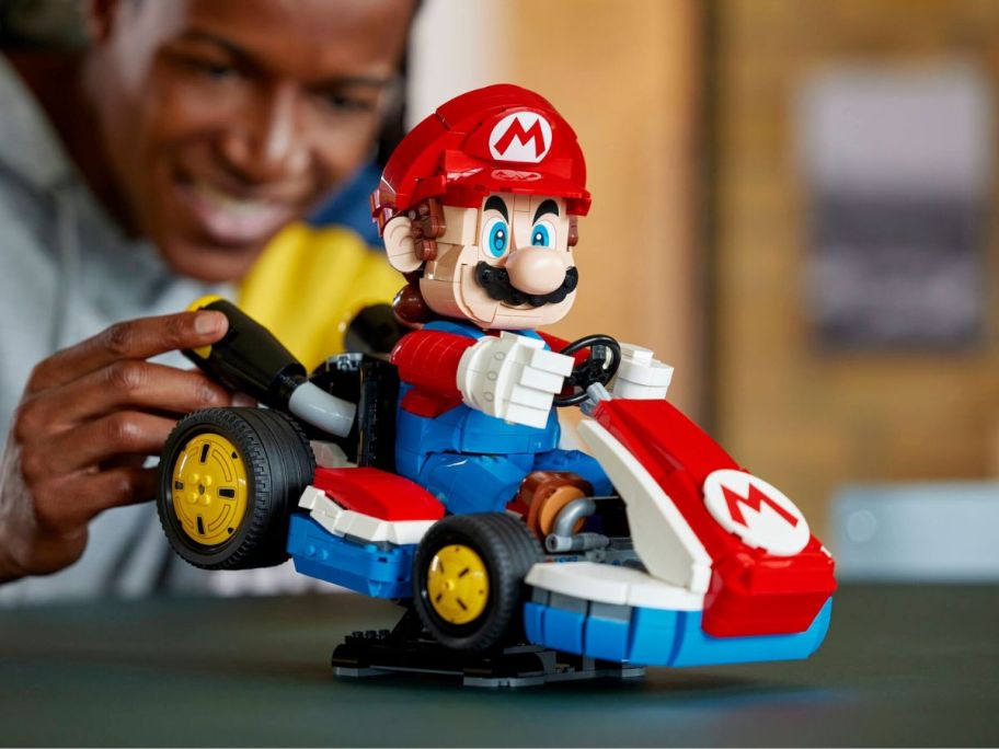 person playing with LEGO Mario Kart - Mario & Standard Kart