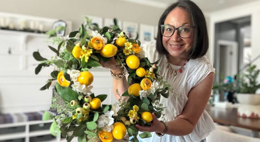 woman holding lemon wreath 