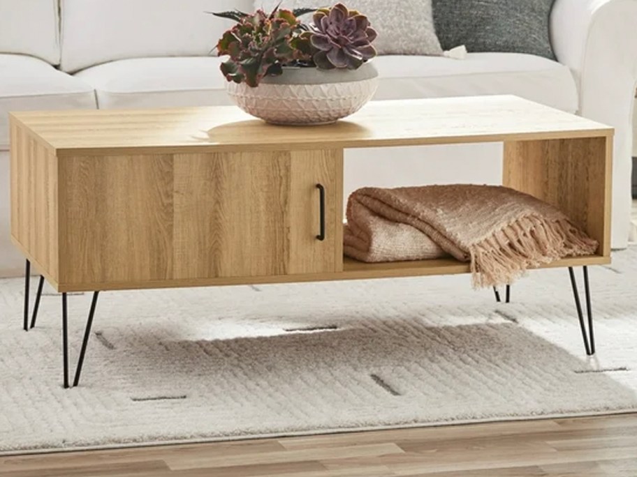 light brown coffee table with flowers on top 