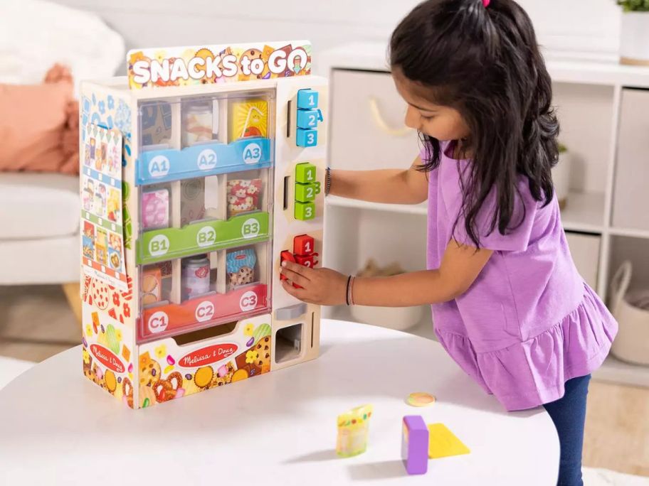 kid playing with Melissa & Doug Sort, Stock, Select Wooden Vending Machine Play Set