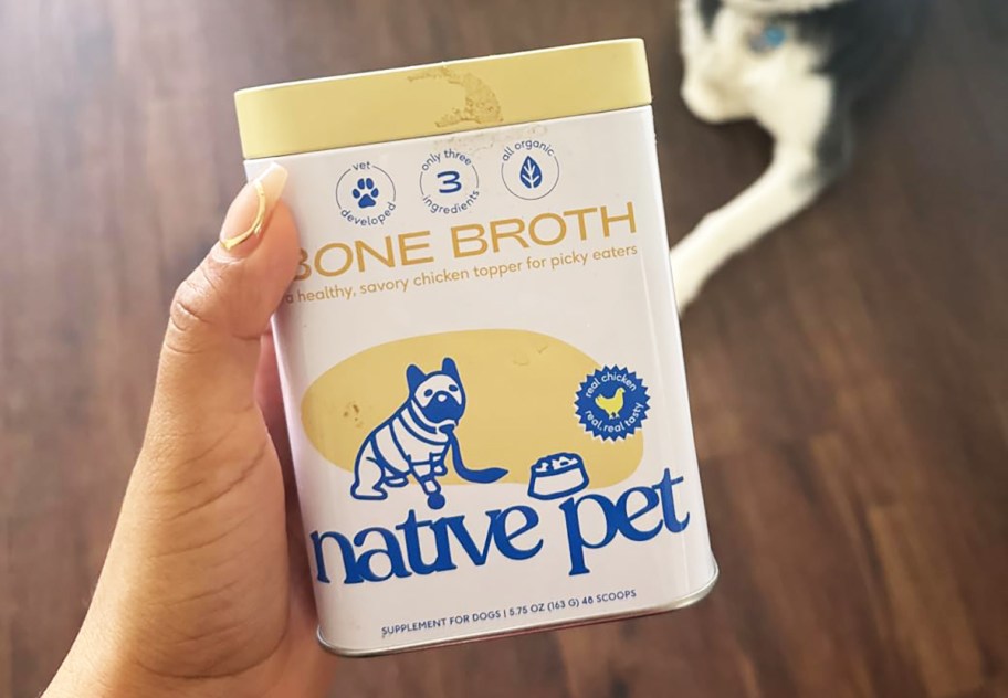 person holding a can of native pet bone broth mix