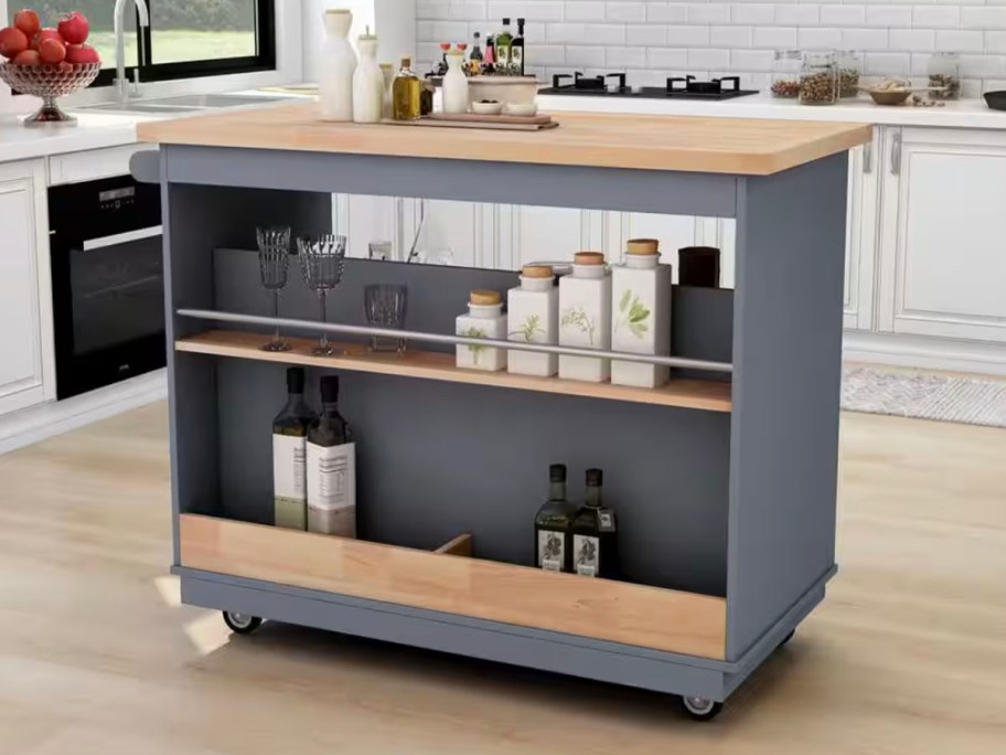 navy blue and wood kitchen island with food on shelves 