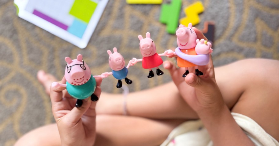 peppa pig toys being held