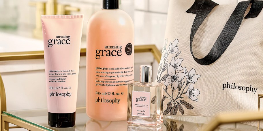 amazing grace exfoliator, shower gel, fragrance and bag on table