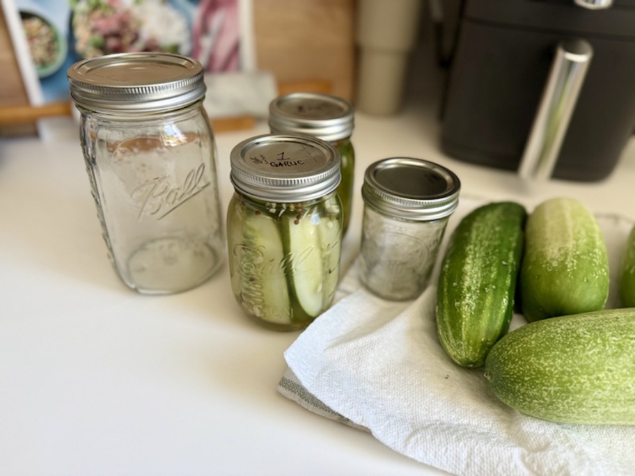 mason jars with cucumbers on kitchen counter