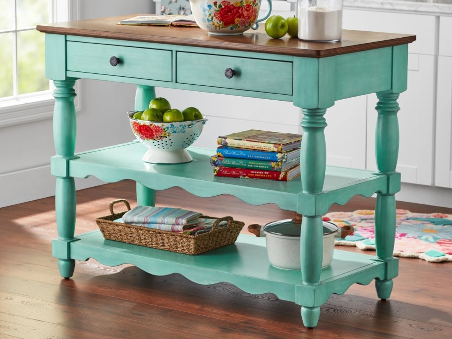 a kitchen cart / bar with a wood top and teal base in a kitchen