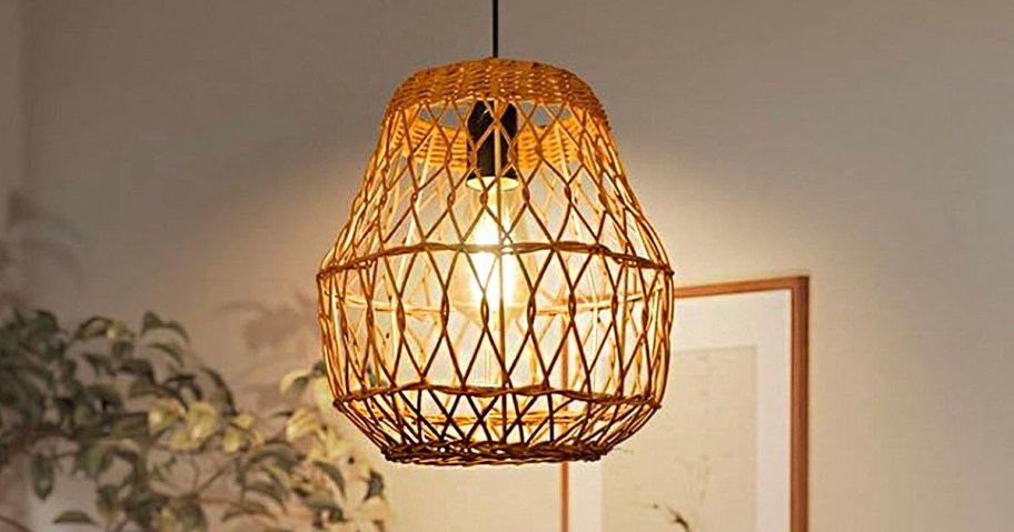 brown rattan pendant light hanging in room 