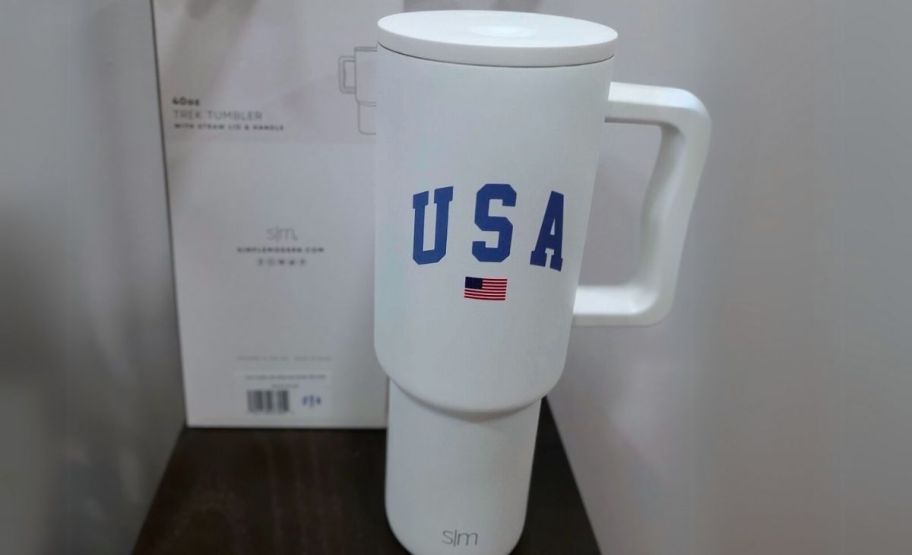 a white USA tumbler with lid and straw
