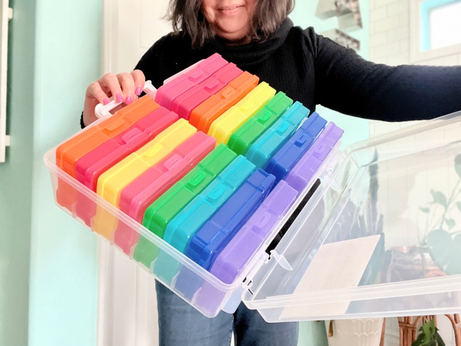 woman holding up a colorful craft organizer