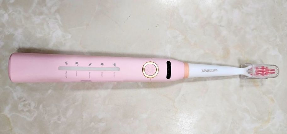 a pink electric toothbrush
