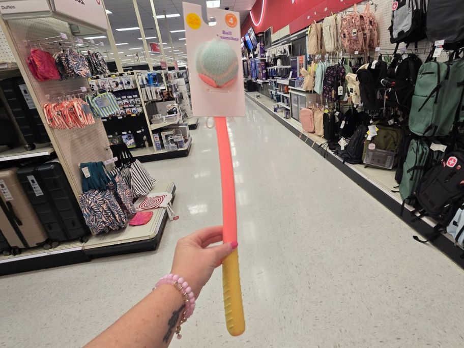 Sun Squad Tennis Ball Launcher Dog Toy in hand in store