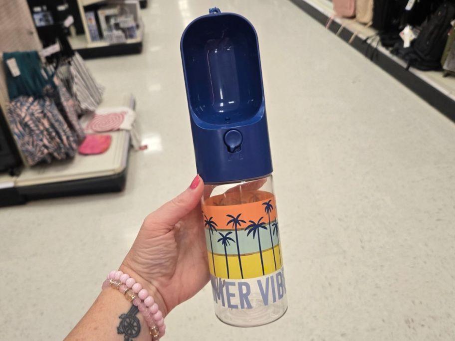 Sun Squad Dog Water Bottle in hand in store