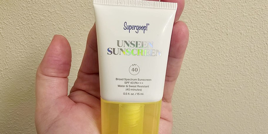 hand holding supergoop unseen sunscreen 