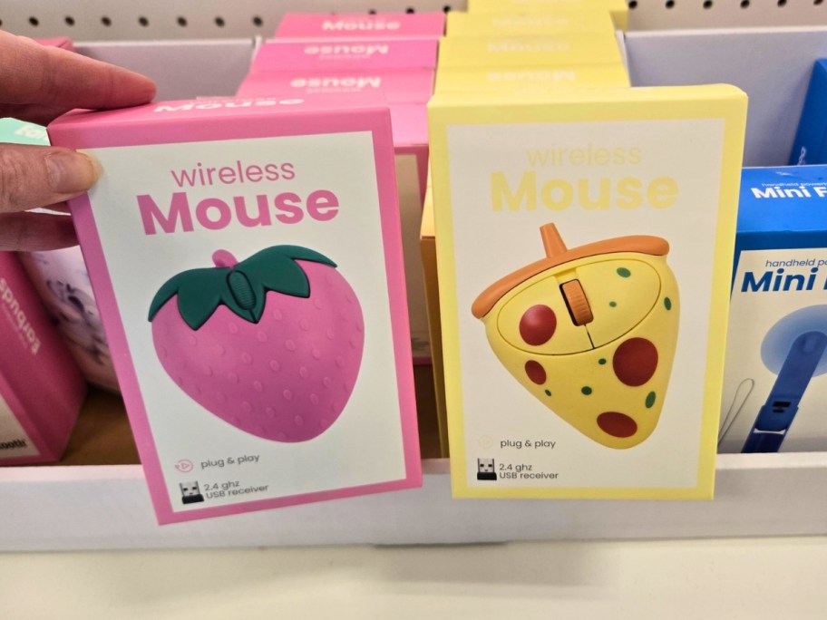 boxes of novelty computer mice on a store shelf that look like a strawberry and slice of pizza