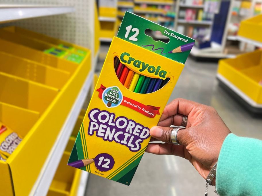Hand holding a box of Crayola Colored Pencils