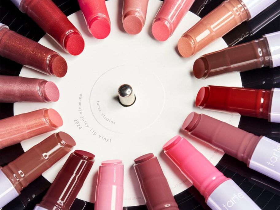 Many shades of tarte maracuja Juicy Lip Vinyl Gloss on a vinyl record