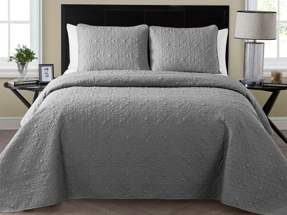 gray quilted bedding set with matching pillows 