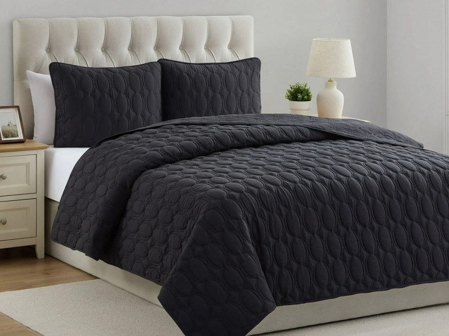 black comforter and pillows on bed 