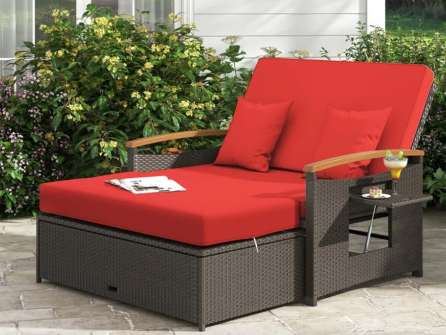 wicker outdoor daybed with red cushions