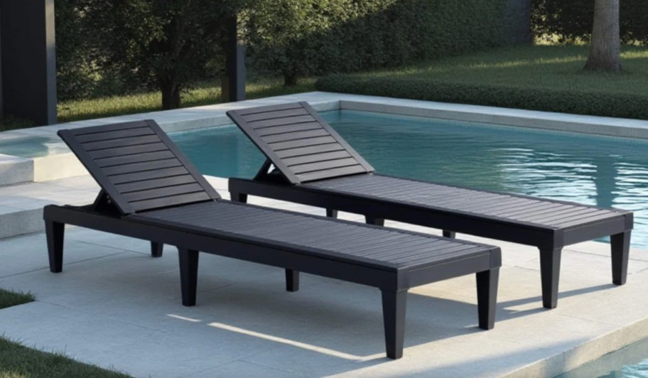 two black lounge chairs near pool