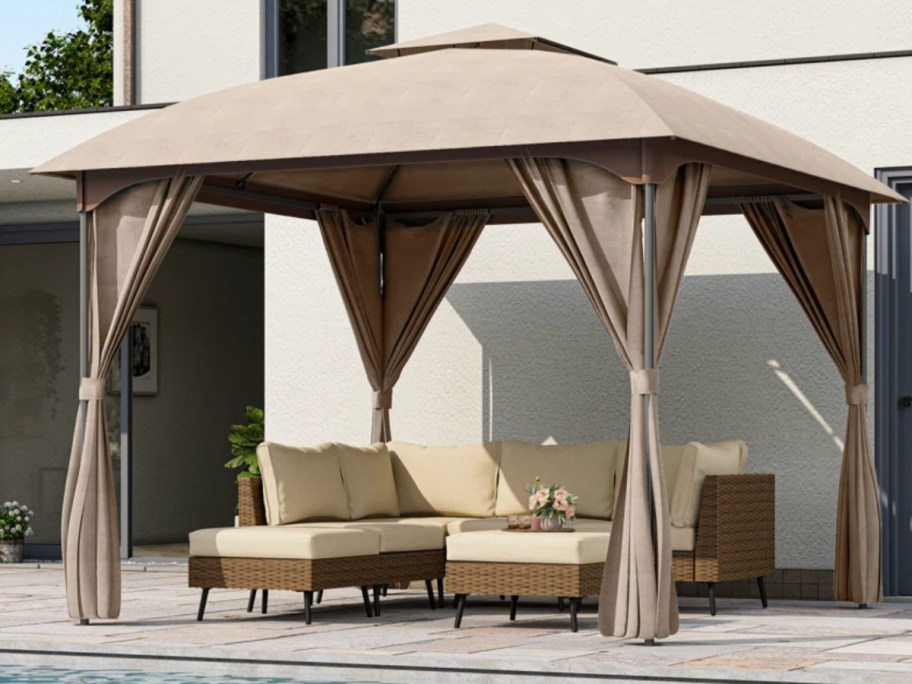 tan gazebo outside next to house