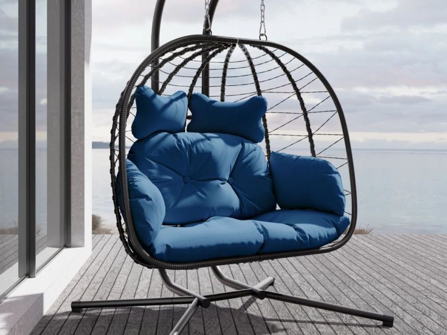 navy blue cushioned egg chair on deck
