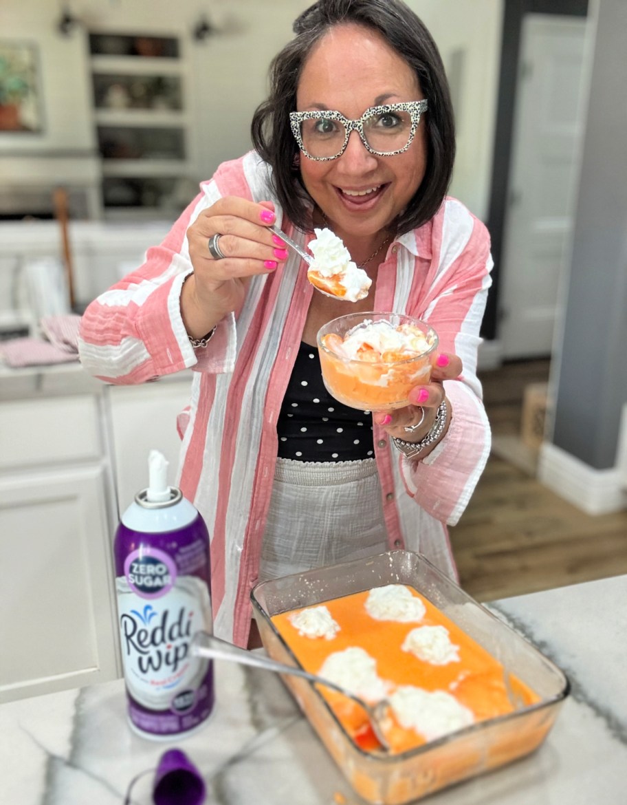 woman holding protein jello with whipped cream on top