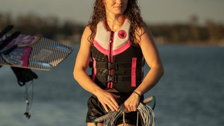 a woman in a black and pink life jacket
