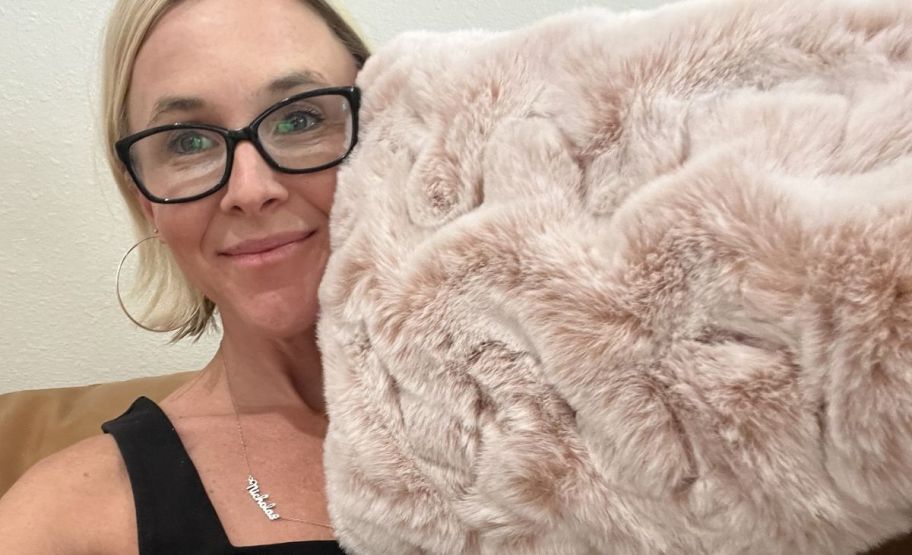 woman with a faux fur pillow